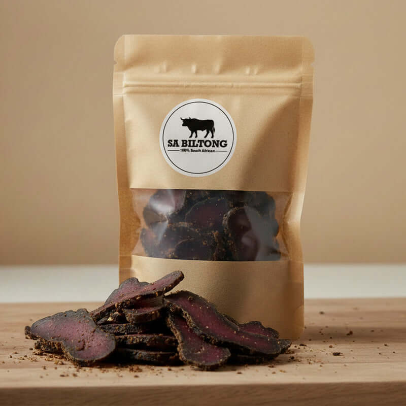 Kudu Biltong - Game Biltong in a brown packaging with sliced pieces on a wooden surface.