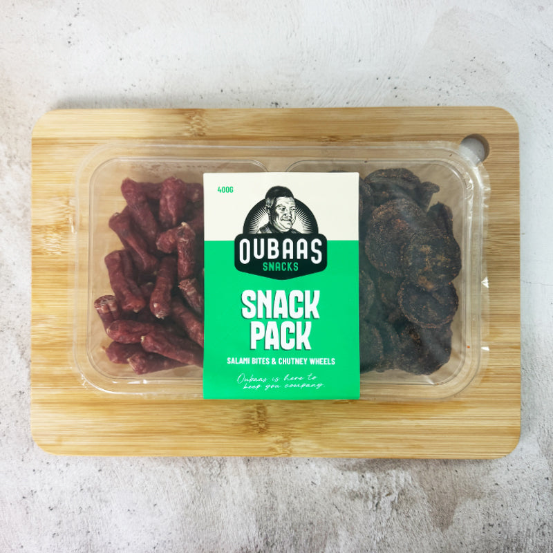 oubaas snack pack on a board in an plastic container that showcase the brand and weight of 400g. This is salami bites and chutney wheels and image is from a top view