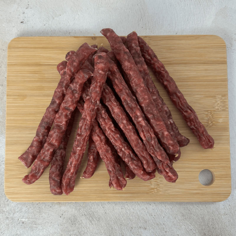 OUBAAS Salami Sticks - 500g displayed on a wooden board, showcasing rich, smoky flavor and premium meat.