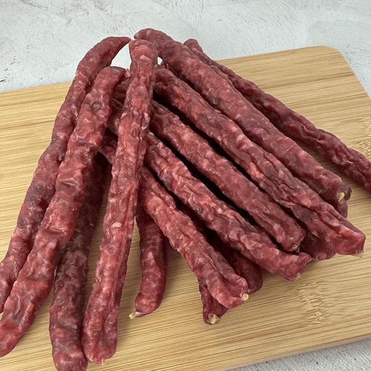 OUUBAAS Salami Sticks - 500g arranged on a wooden board for snacking, showcasing rich color and texture.