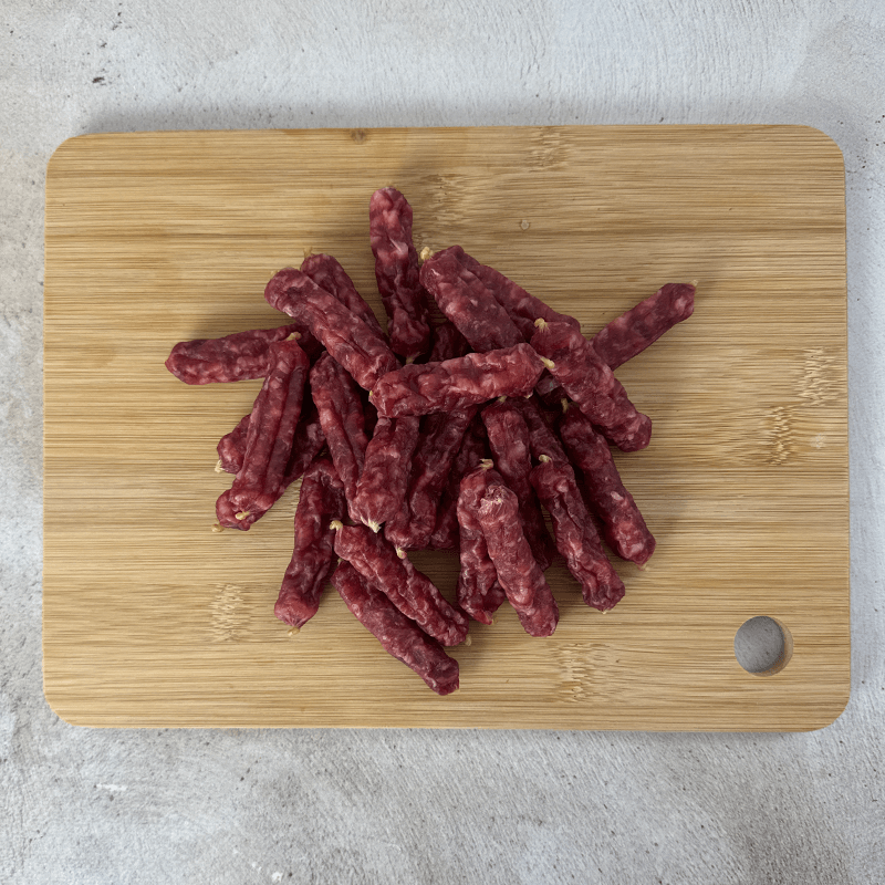 salami bites on a wooden cutting board
